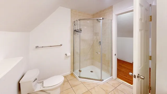 a bathroom with a shower a toilet and sink