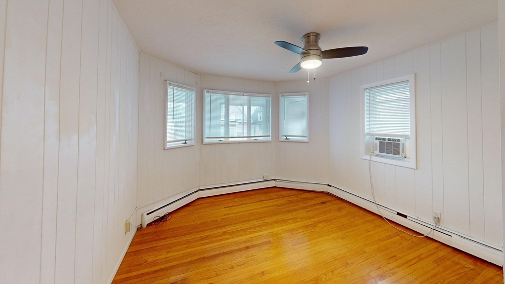 78 Fremont Street, Unit 78 Somerville, MA 02145 - Photo 25 of 30 a view of empty room with wooden floor and ceiling fan