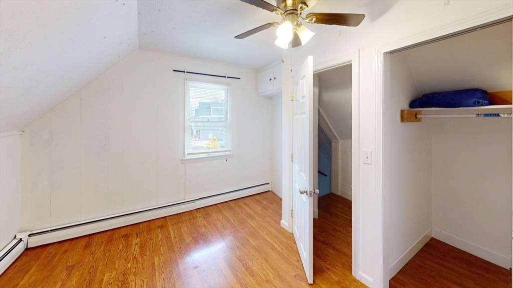 78 Fremont Street, Unit 78 Somerville, MA 02145 - Photo 27 of 30 a view of an empty room with wooden floor and a window