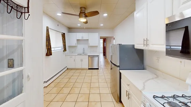 a kitchen with a sink a stove and cabinets