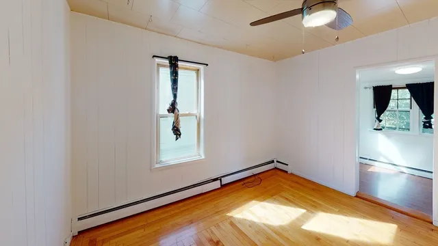 wooden floor in an empty room with a window