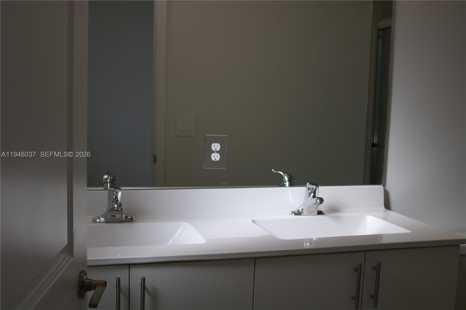 23040 Southwest 99th Court Cutler Bay, FL 33190 - Photo 18 of 23 a bathroom with a sink and a mirror