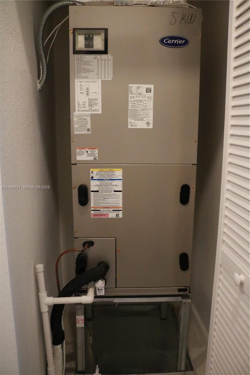 23040 Southwest 99th Court Cutler Bay, FL 33190 - Photo 23 of 23 a bathroom with a sink a toilet and a mirror