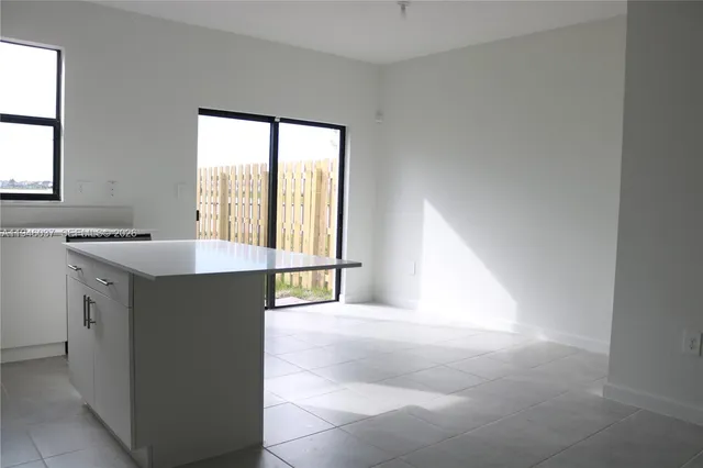 a kitchen with a stove a sink and a refrigerator