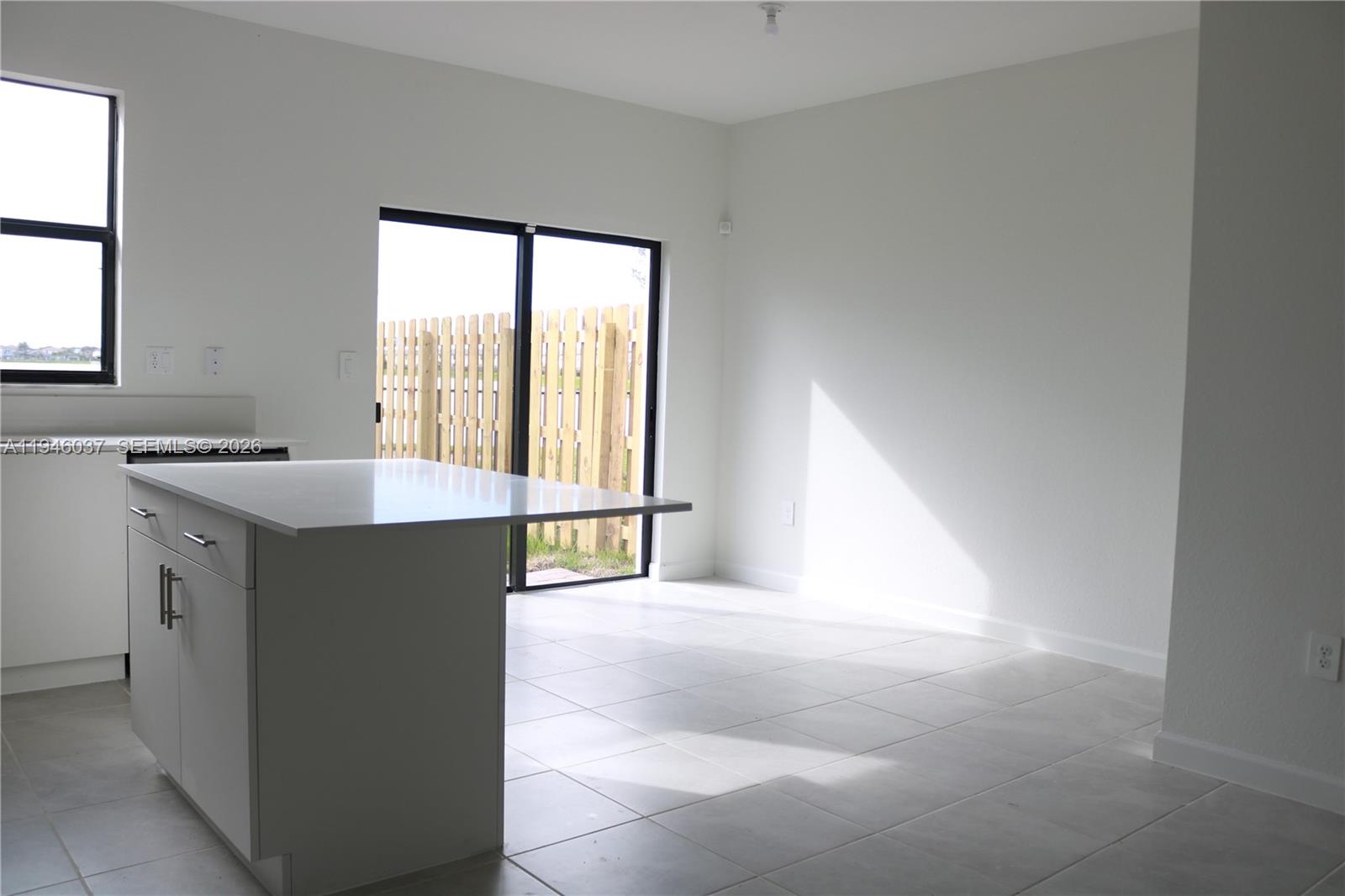 23040 Southwest 99th Court Cutler Bay, FL 33190 - Photo 3 of 23 a kitchen with a stove a sink and a refrigerator