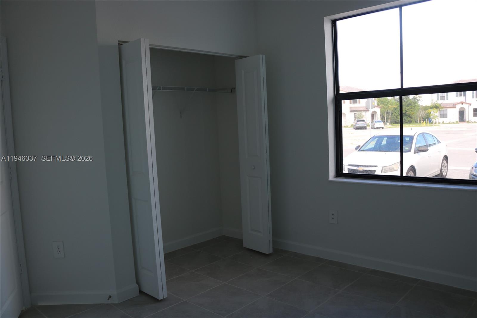 23040 Southwest 99th Court Cutler Bay, FL 33190 - Photo 8 of 23 an empty room with a window