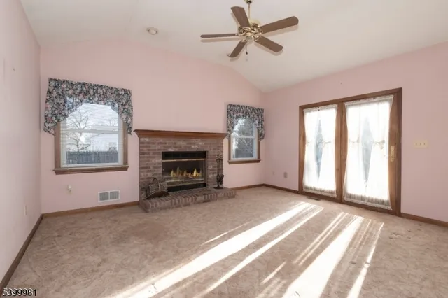 an empty room with closet and a hallway