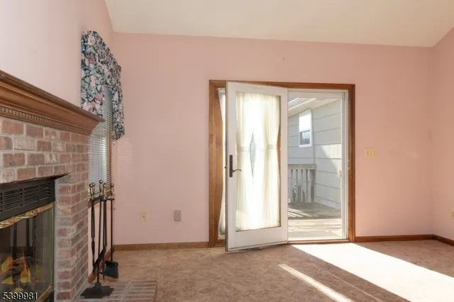 an empty room with wooden floor ceiling fan and windows