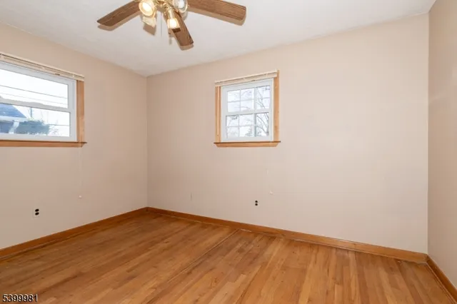 an empty room with closet and a hallway