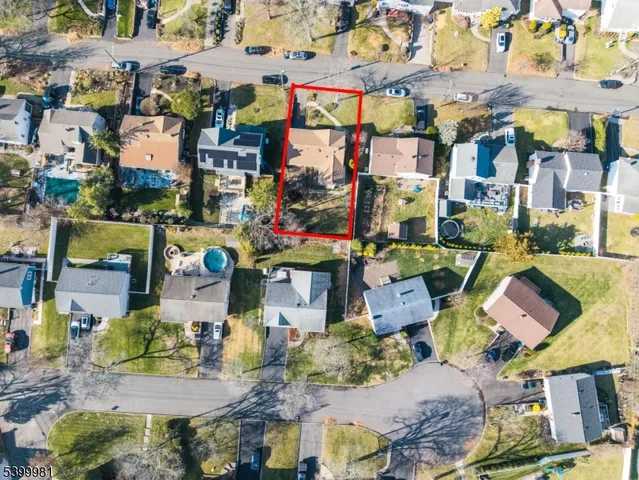 a view of a livingroom with wooden floor and a ceiling fan