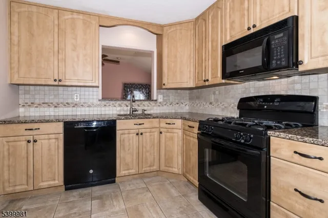 a kitchen with a sink stove and microwave
