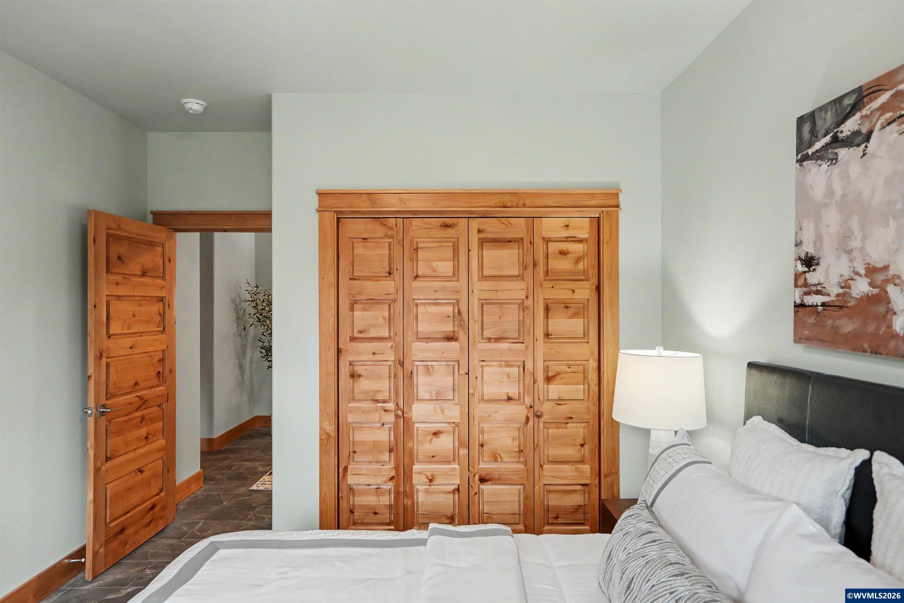 1155 Northwest Country Hills Road Corvallis, OR 97330 - Photo 16 of 48 a bedroom with a bed and a dresser next to a window