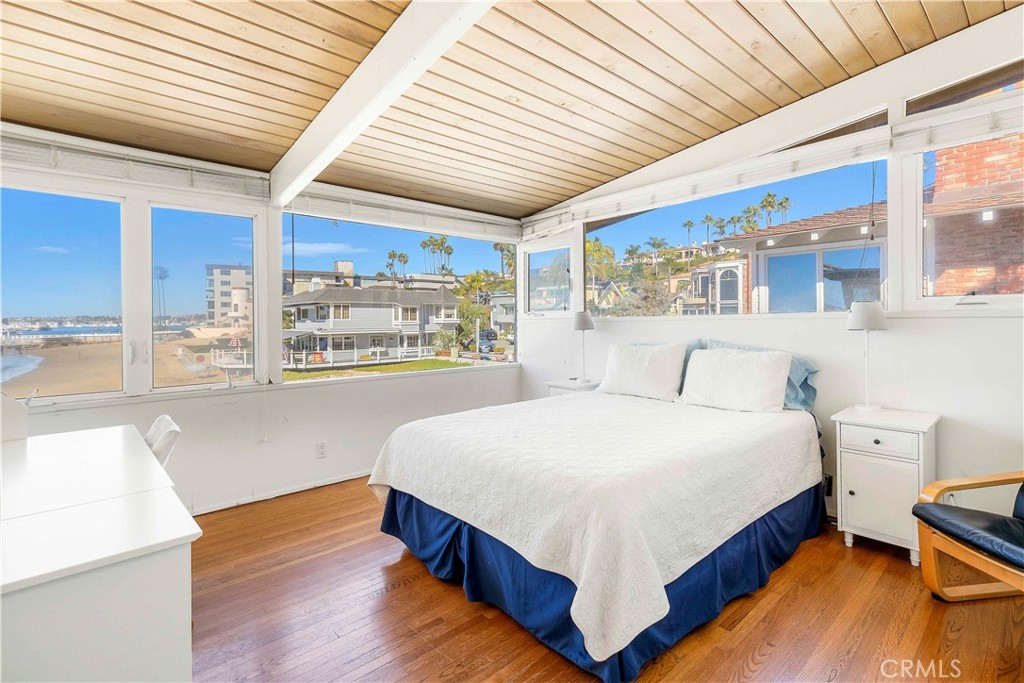 2708 Shell Street Corona del Mar, CA 92625 - Photo 13 of 33 a bedroom with a large bed and a large window