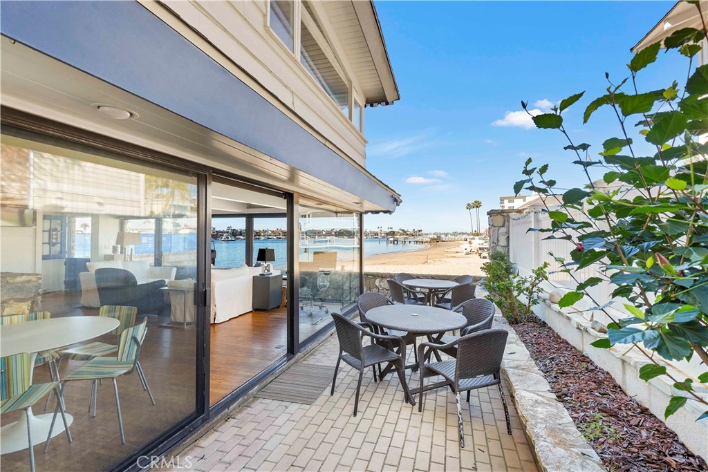 2708 Shell Street Corona del Mar, CA 92625 - Photo 17 of 33 a dining room with furniture and a floor to ceiling window