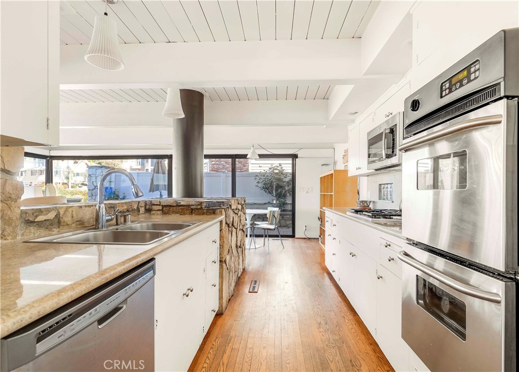 2708 Shell Street Corona del Mar, CA 92625 - Photo 7 of 33 a large kitchen with stainless steel appliances granite countertop a lot of counter space and wooden floors