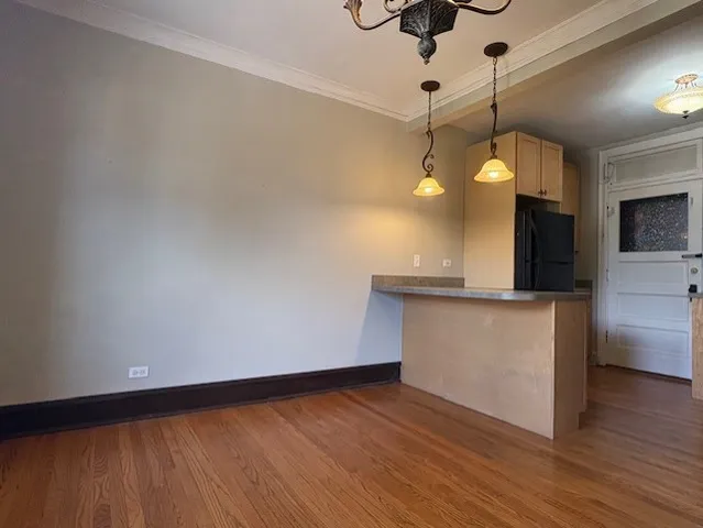 a view of kitchen with wooden floor and a ceiling fan