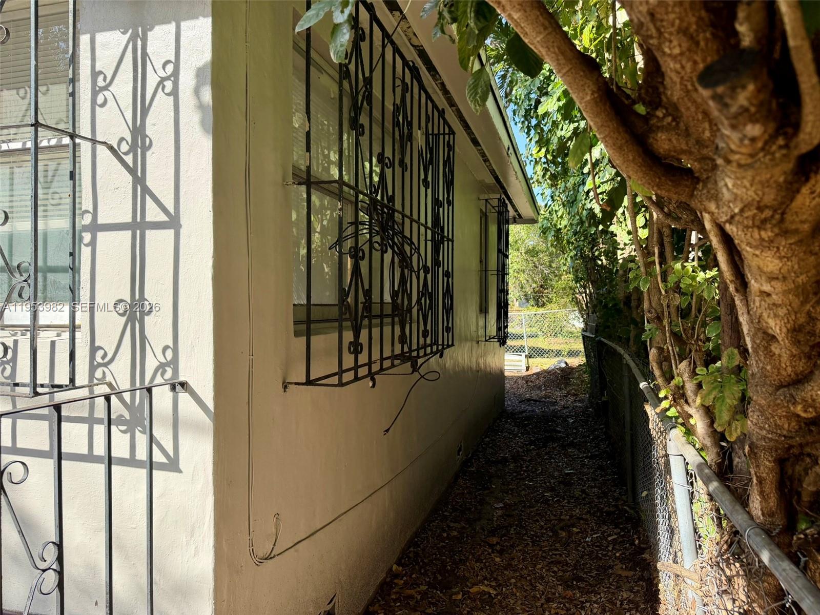 413 Northwest 63rd Street Miami, FL 33150 - Photo 12 of 55 a view of a pathway of a house with a yard