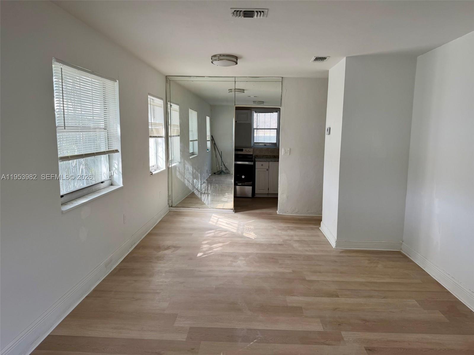 413 Northwest 63rd Street Miami, FL 33150 - Photo 24 of 55 a view of a room with window and hardwood floor