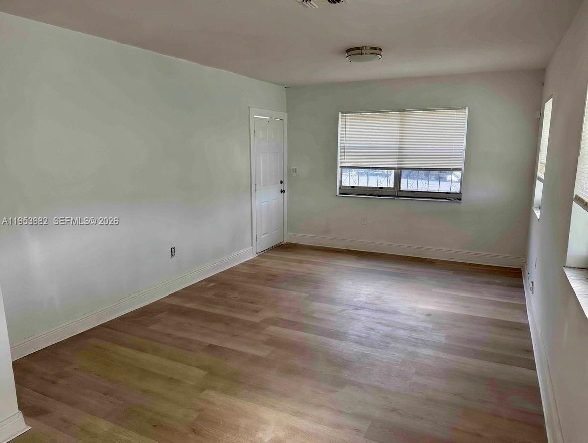 413 Northwest 63rd Street Miami, FL 33150 - Photo 25 of 55 an empty room with wooden floor and windows