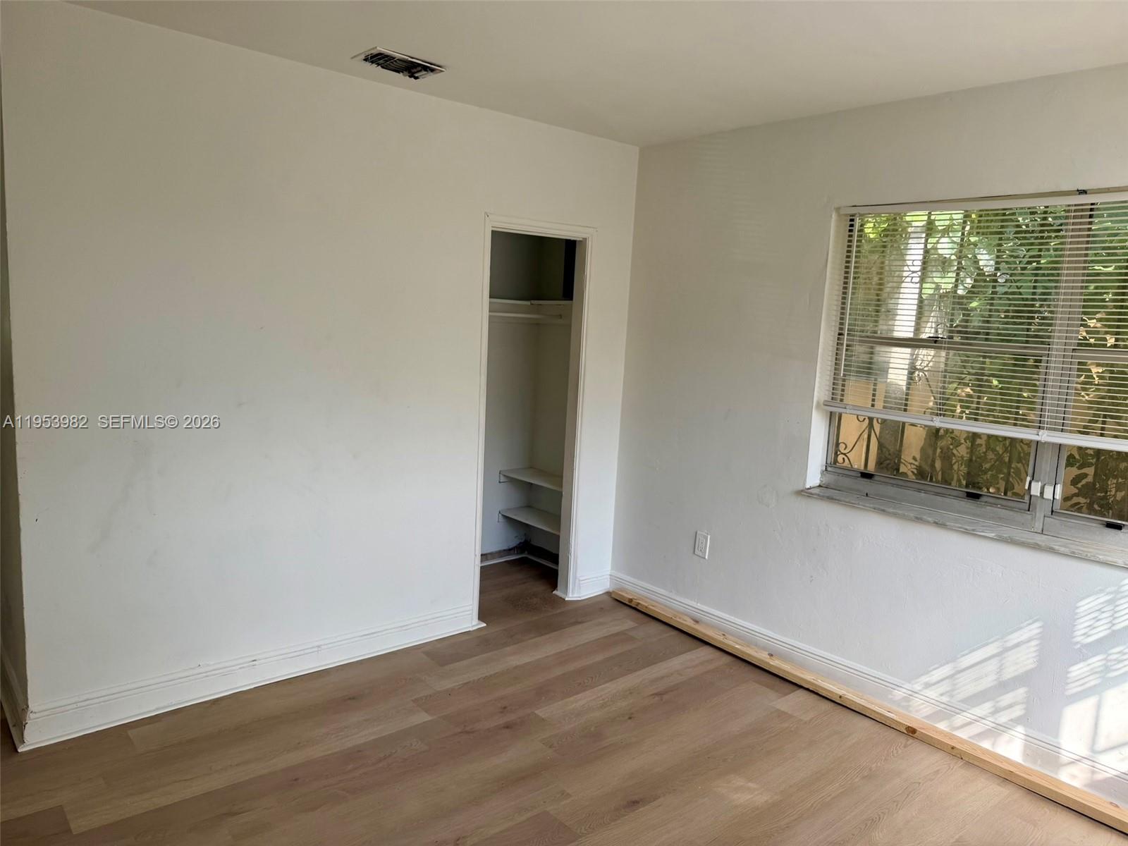 413 Northwest 63rd Street Miami, FL 33150 - Photo 27 of 55 an empty room with wooden floor and windows