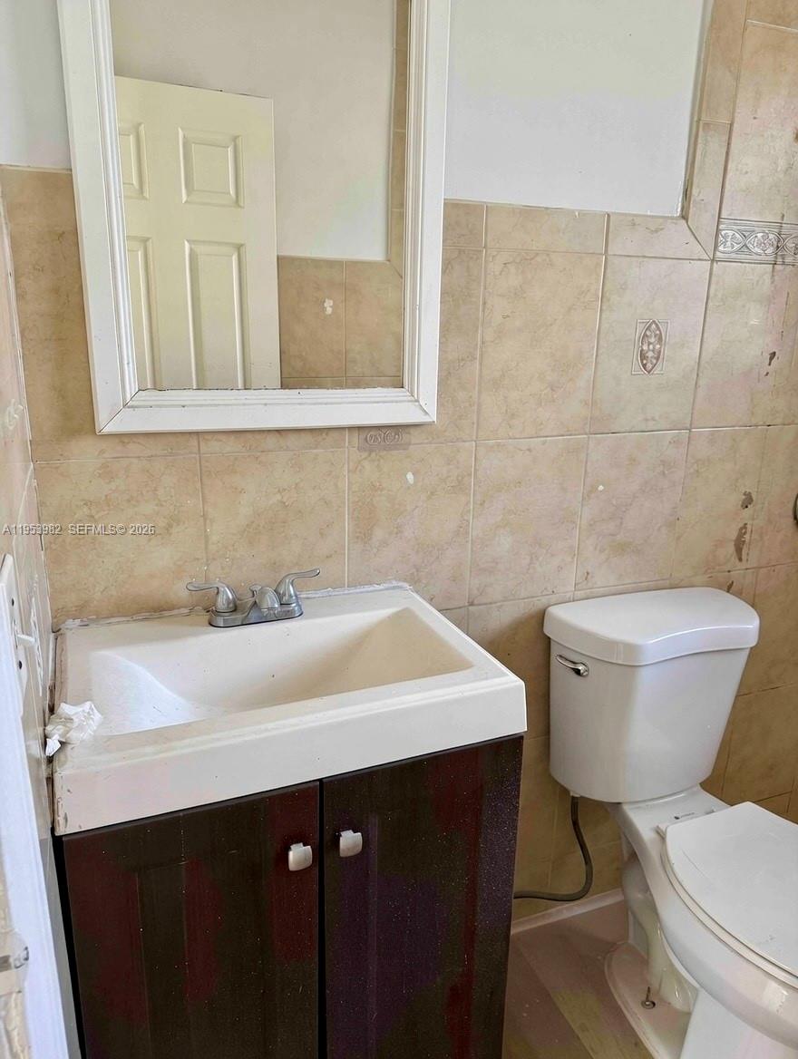 413 Northwest 63rd Street Miami, FL 33150 - Photo 38 of 55 a bathroom with a sink a toilet and a mirror