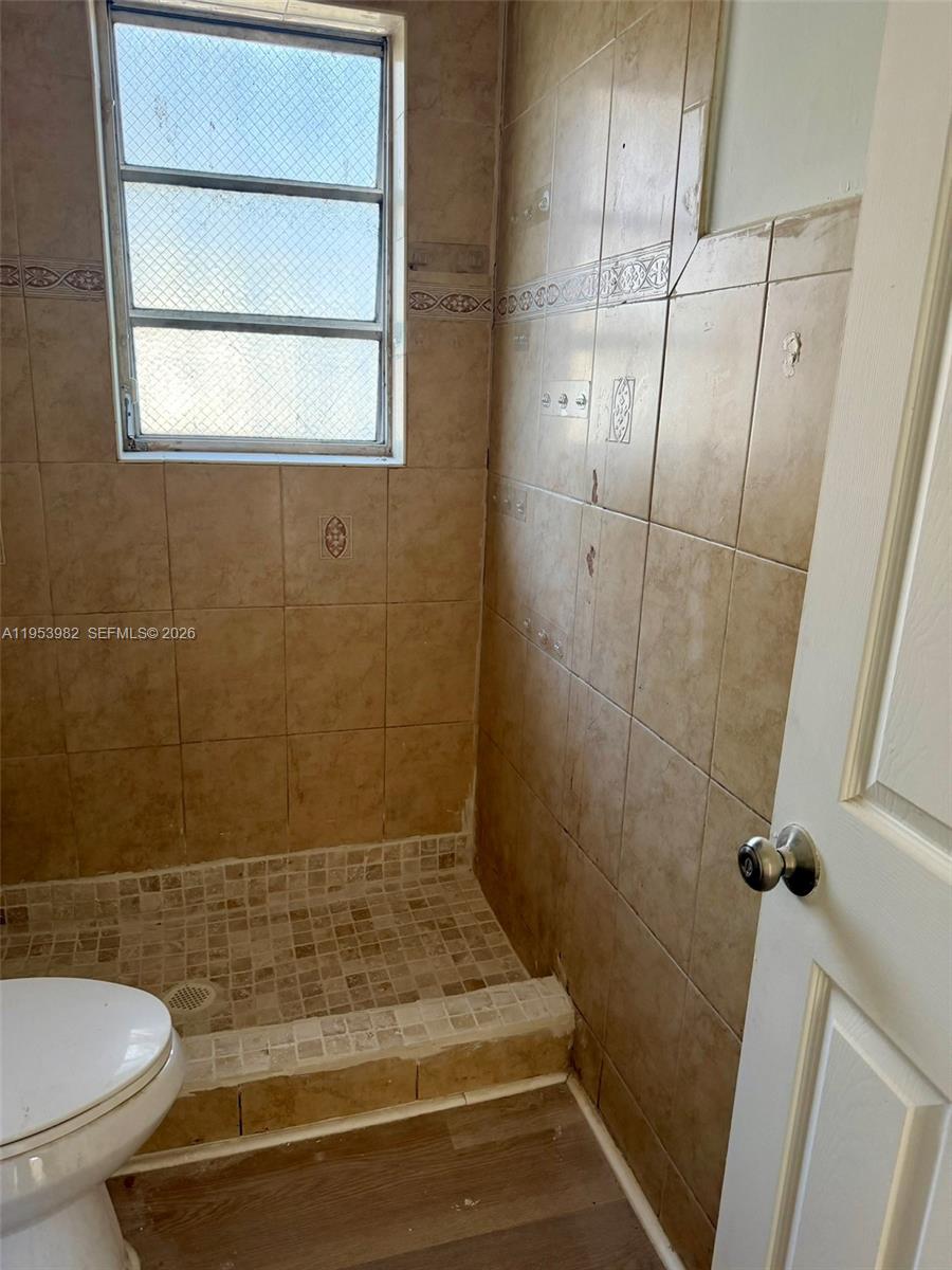 413 Northwest 63rd Street Miami, FL 33150 - Photo 40 of 55 a bathroom with a sink and a shower