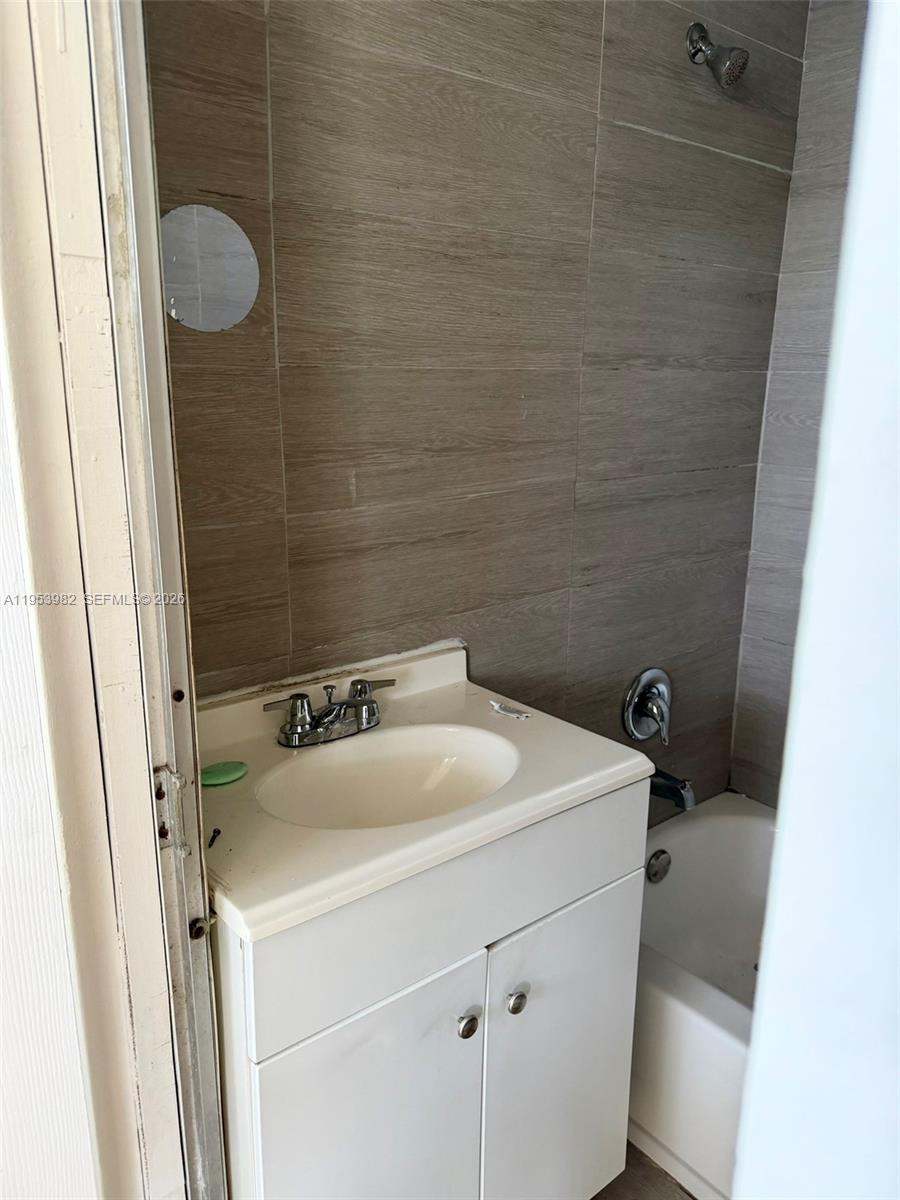 413 Northwest 63rd Street Miami, FL 33150 - Photo 46 of 55 a bathroom with a sink and shower