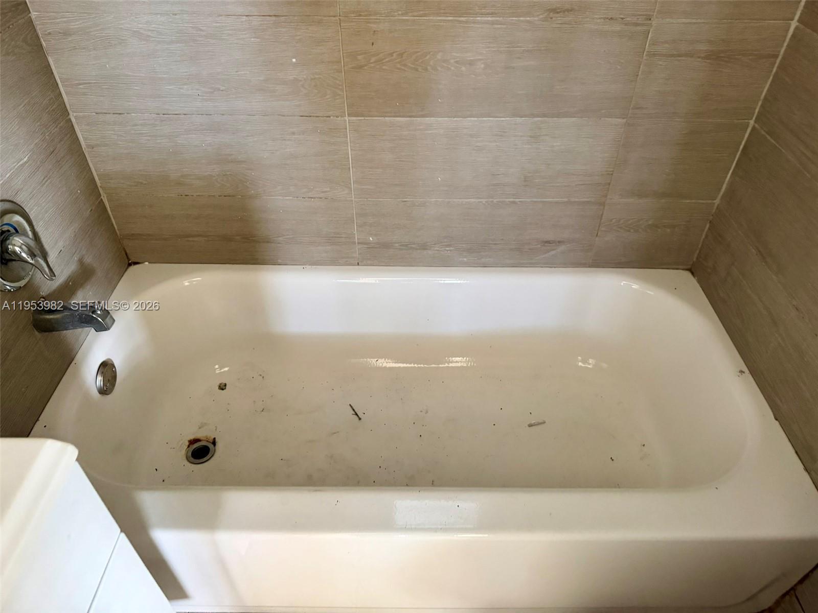 413 Northwest 63rd Street Miami, FL 33150 - Photo 48 of 55 a bathroom with a tub