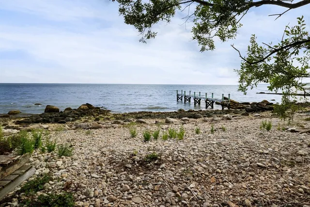 a view of a yard with wooden fence