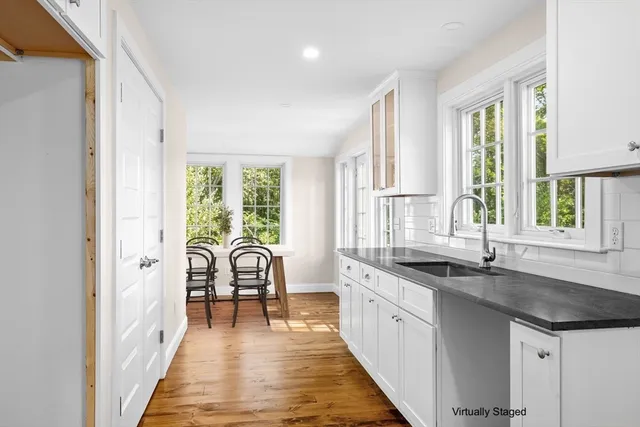 a kitchen with granite countertop a sink and a window