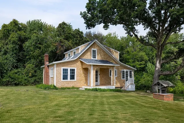 a front view of a house with a garden