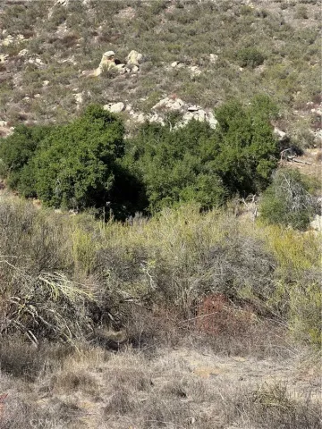 a view of a large mountain with mountains in the background