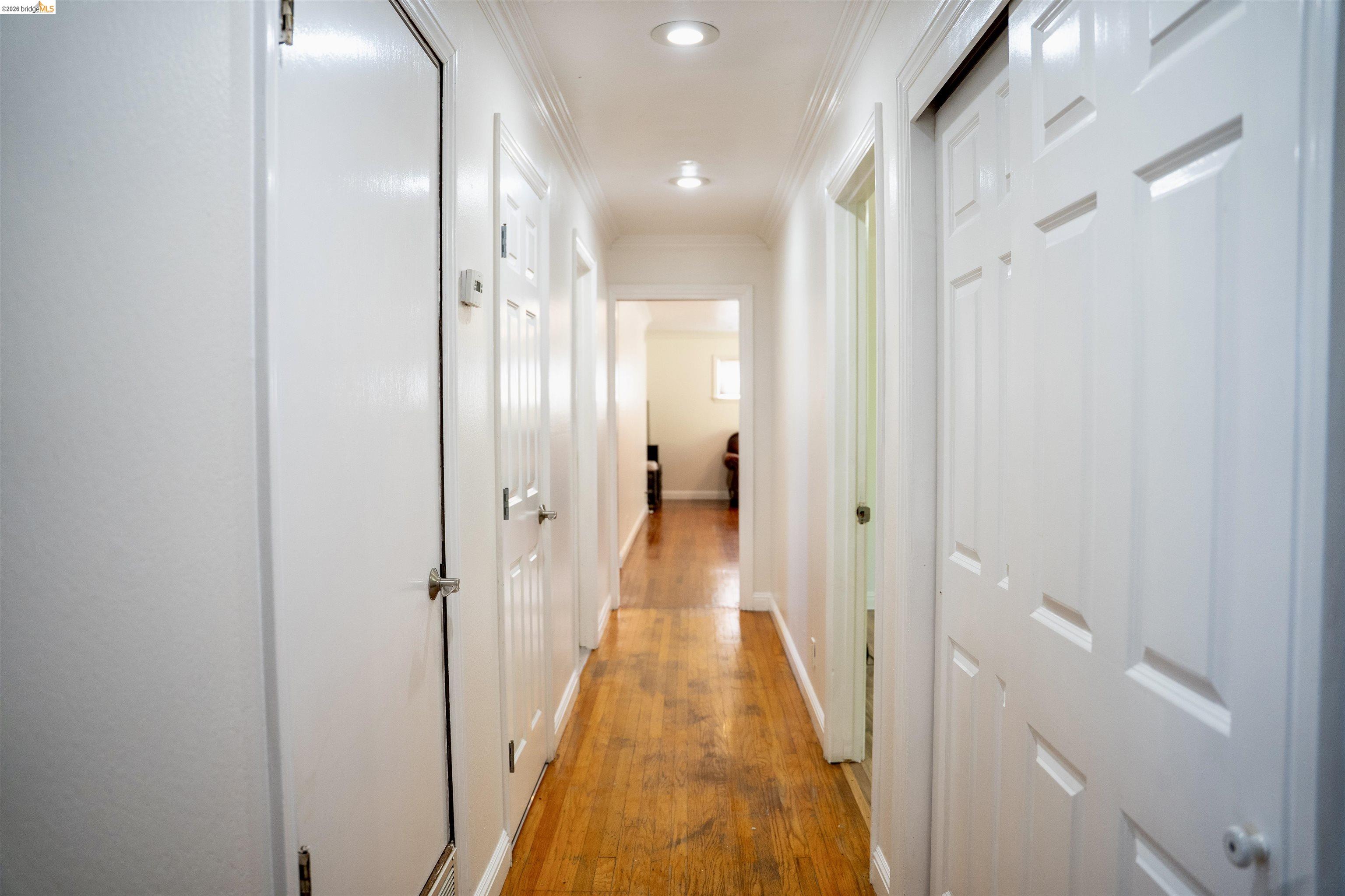 64 Washington Street Novato, CA 94947 - Photo 12 of 21 Hallway featuring wood-finish flooring, recessed lighting, and crown molding