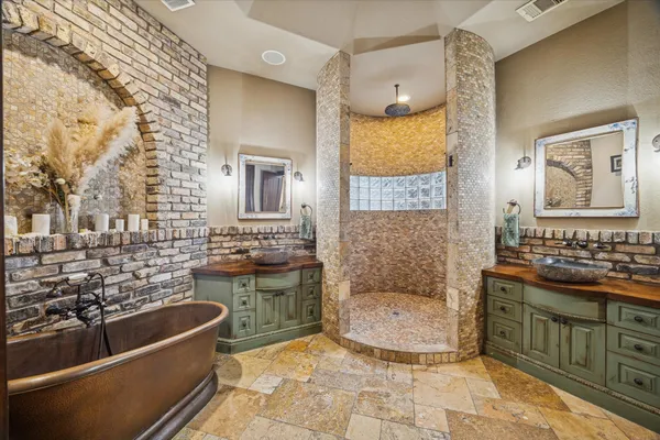 a bathroom with a granite countertop double vanity sink and a mirror