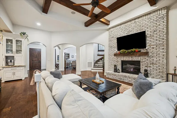 a living room with furniture a fireplace and a flat screen tv