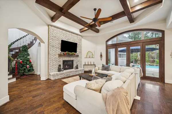 a living room with furniture and wooden floor