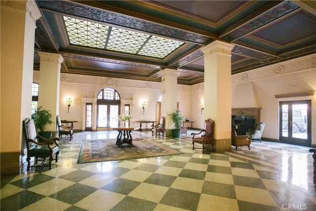 a living room with fireplace furniture and a potted plant