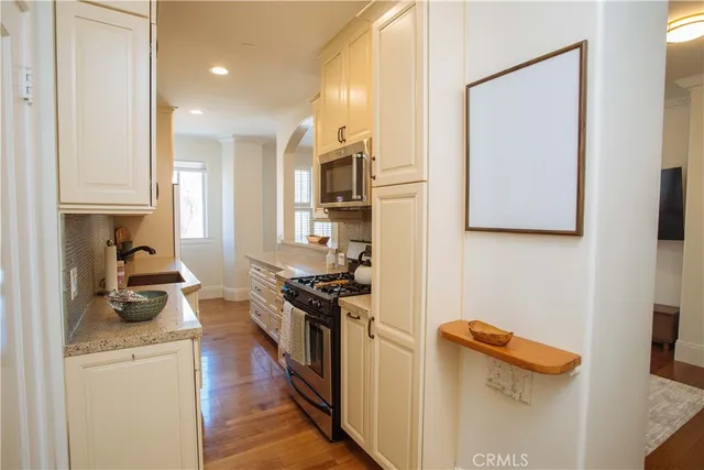 a kitchen with a refrigerator and a stove
