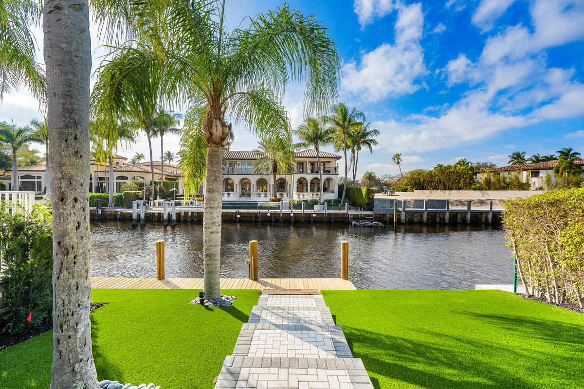 533 East Alexander Palm Road Boca Raton, FL 33432 - Photo 11 of 44 a view of a lake with a house next to a yard