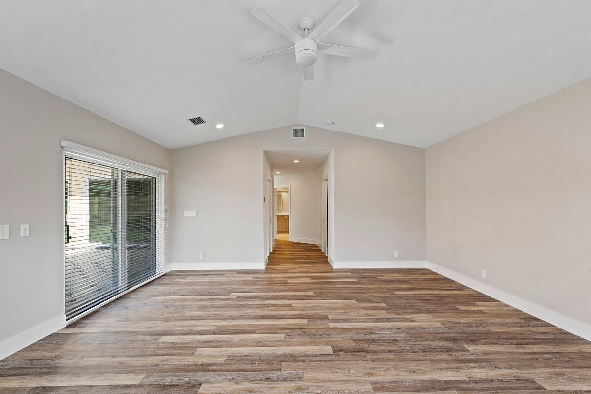 533 East Alexander Palm Road Boca Raton, FL 33432 - Photo 27 of 44 a view of an empty room with wooden floor and a window