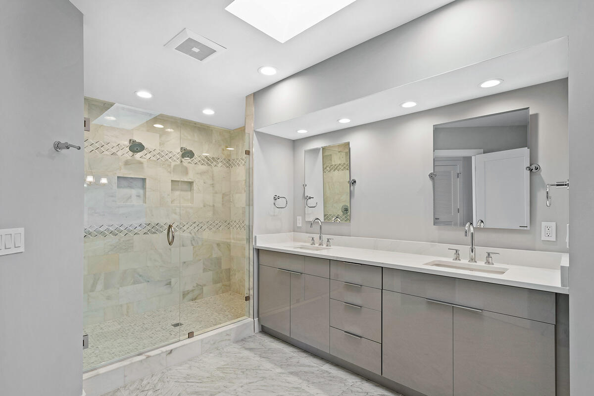 533 East Alexander Palm Road Boca Raton, FL 33432 - Photo 29 of 44 a bathroom with a shower sink double and mirror