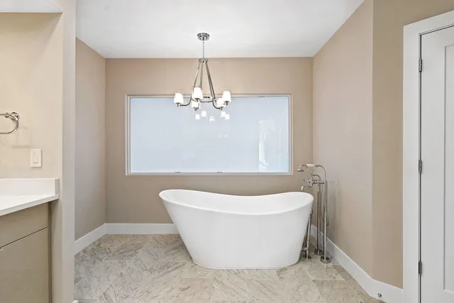 a white bath tub sitting in a bathroom