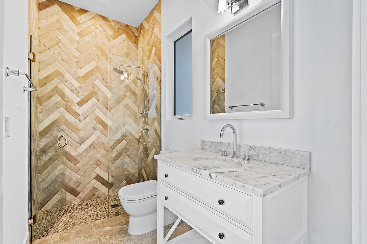 533 East Alexander Palm Road Boca Raton, FL 33432 - Photo 33 of 44 a bathroom with a granite countertop sink a toilet and a mirror