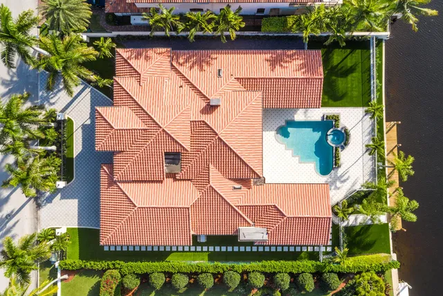 an aerial view of a house with a yard and potted plants
