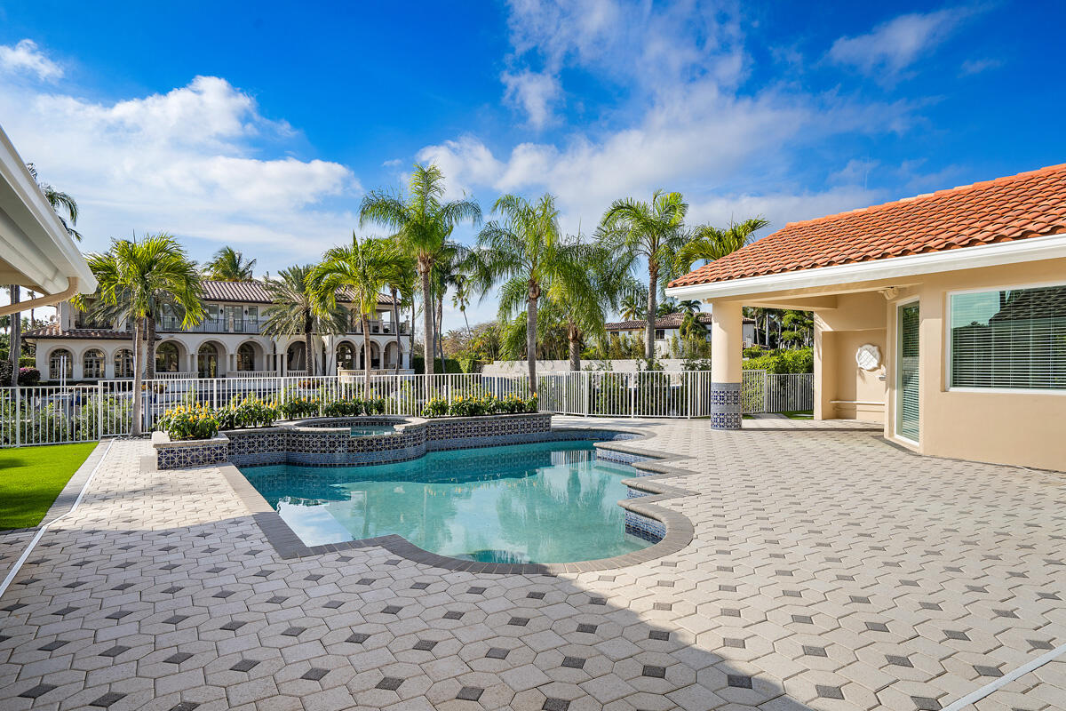 533 East Alexander Palm Road Boca Raton, FL 33432 - Photo 9 of 44 a view of a swimming pool with a patio