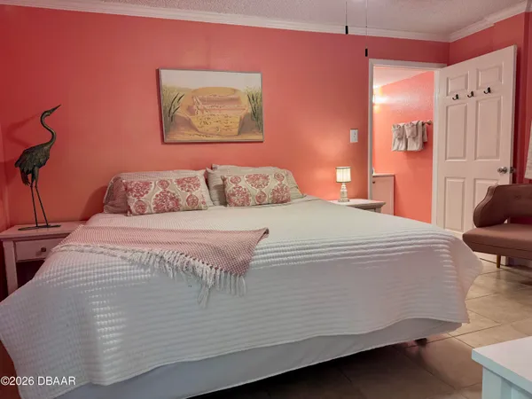 a bedroom with a bed and a couch