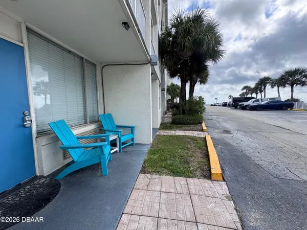 a backyard of a house with table and chairs