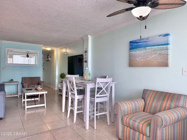 a living room with furniture a window and a flat screen tv