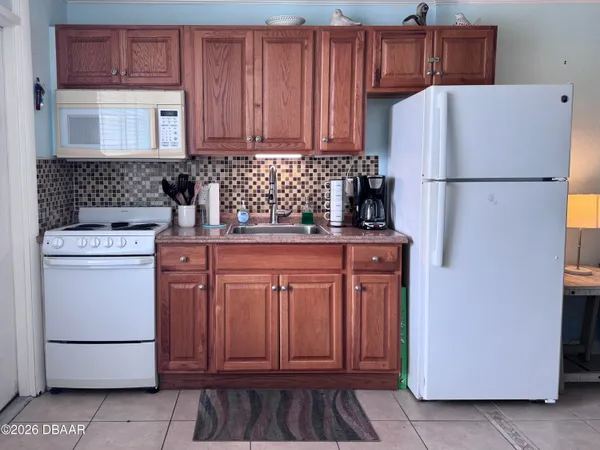 a kitchen with stainless steel appliances granite countertop a refrigerator stove a sink and dishwasher