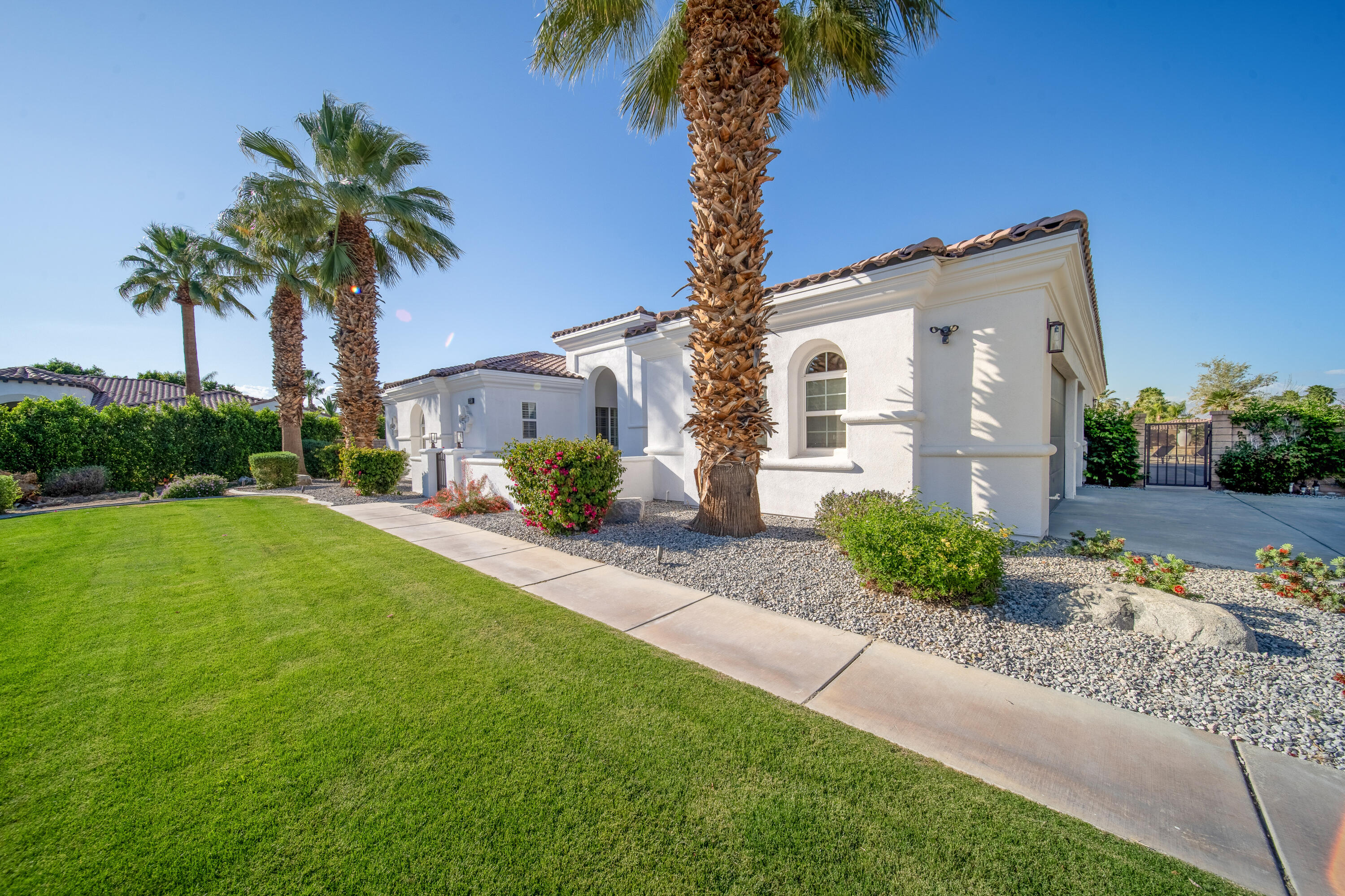 80262 Amazon Avenue Indio, CA 92201 - Photo 5 of 69 a front view of a house with garden and a tree